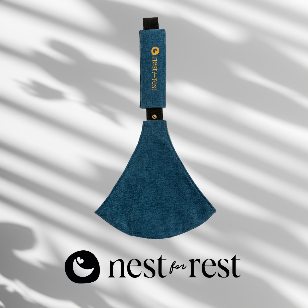 Nest for Rest Ocean Blue toddler carrier featuring a sleek design with a golden logo, shown against a light background with shadow effects. The carrier is compact and designed for comfort and style, suitable for toddlers aged 9 months to 4 years.